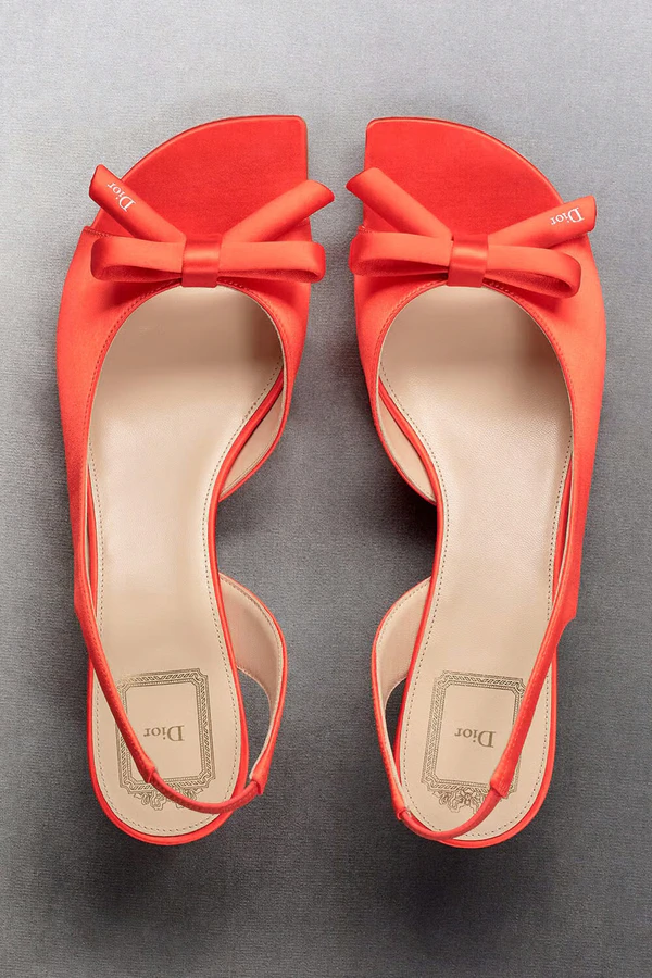<a href="https://www.dior.com/en_us/fashion/products/KCO577SAT_S42R">DIOR Bow Heeled Slingback Sandal</a>, $1,190