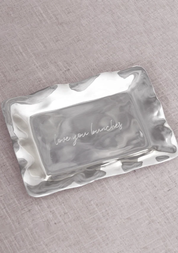 <a href="https://beatrizball.com/products/giftables-engraved-tray-love-you-bunches?variant=46619938750755&country=US&currency=USD&utm_medium=product_sync&utm_source=google&utm_content=sag_organic&utm_campaign=sag_organic&gad_source=1&gad_campaignid=734973801&gbraid=0AAAAADcG6O_O2QyhiUYLrYPZ3siIAQ5XK&gclid=EAIaIQobChMIv5y2sZiClwMVIET_AR2iAilZEAQYBCABEgLAVPD_BwE">BEATRIZ BALL Engraved Tray, $51</a>