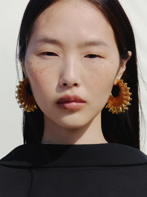 <a href="https://www.jacquemus.com/en_us/the-hippocampe-hoop-earrings/JWW00802AOT4063280.html">JACQUEMUS Earrings</a>, $490