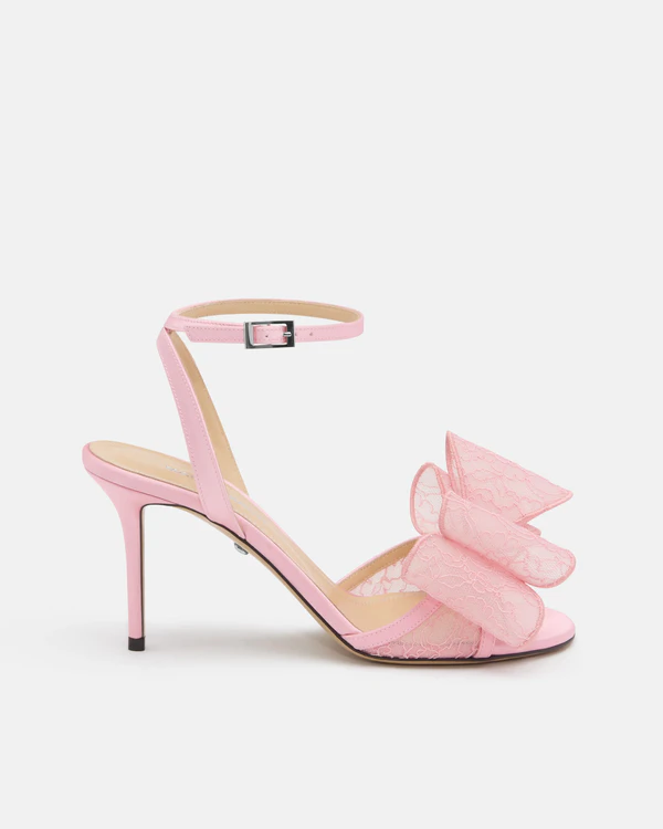 <a href="https://machandmach.com/products/le-cadeau-white-lace-slingback?_gl=1*khfpzl*_up*MQ..*_ga*OTE1MDcxMTA2LjE3ODE4OTQ2NjA.*_ga_N8QBVBWCCC*czE3ODE4OTQ2NTkkbzEkZzEkdDE3ODE4OTQ2NjckajUyJGwwJGgw&variant=47851547394296">MACH & MACH Le Cadeau Pink Lace Sandals</a>, $1,045