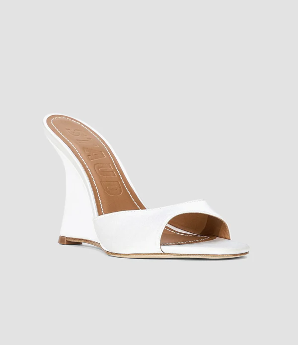 <a href="https://www.saksfifthavenue.com/product/staud-brigitte-100mm-satin-wedge-sandals-0400026077268.html?dwvar_0400026077268_size=38+%288%29&amp;dwvar_0400026077268_color=IVORY&amp;site_refer=CSE_GGLPLA%3AWomen%27s+Shoes%3ASTAUD&amp;country=US&amp;currency=USD&amp;site_refer=360i+G+CSE&amp;kw_refer=%24SAKS_G_PLA_Women%27s+Shoes_Baseline%24SAKS_G_PLA_Women%27s+Shoes_Baseline_Women%27s+Shoes%24PRODUCT_GROUP&amp;gclsrc=aw.ds&amp;gad_source=1&amp;gad_campaignid=23019487410&amp;gbraid=0AAAAADO6JtTuakB2sNmZYgCkx_f14gUIa&amp;gclid=CjwKCAjw_KjVBhAHEiwAnC0N9BahXnrxdR2sPfXR2lPXBgQgjqdrbYOveKgdJUw9FzDKNWv1jiHrBRoC4JYQAvD_BwE">STAUD Satin Wedge Sandals from Saks Fifth Avenue, $395</a>