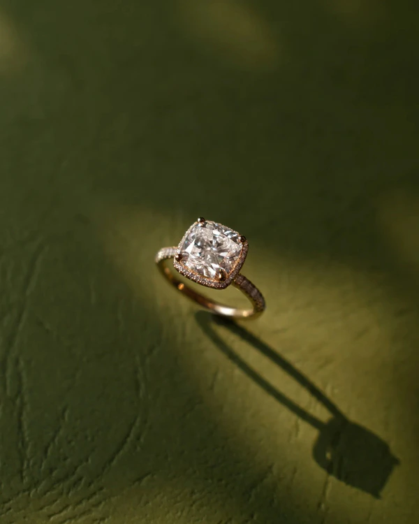<a href="https://tinxxjewelry.com/collections/engagement/products/cushion-cut-halo-pave-ring">Tinxx</a>