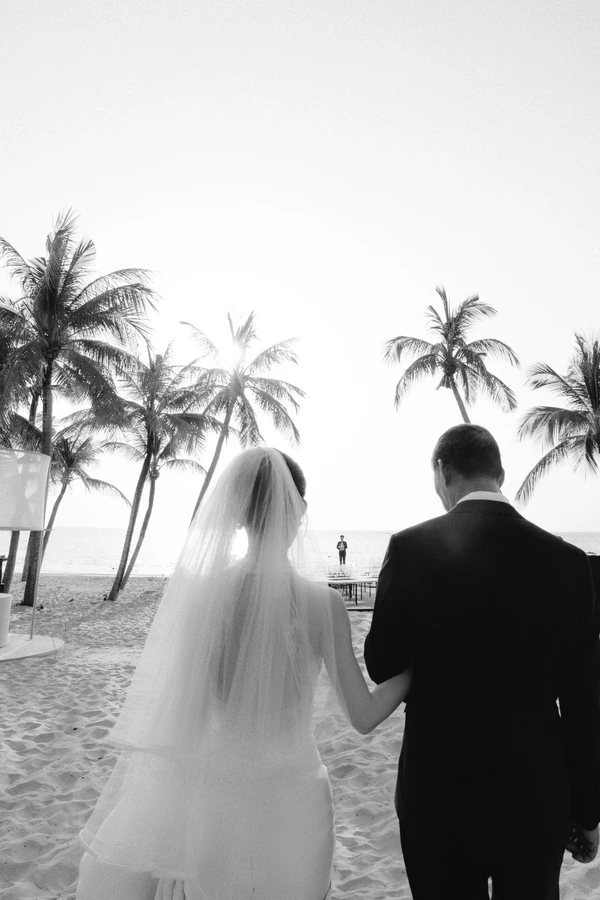 A Cinematic Beach Wedding in Vietnam with a Sunset Ceremony Framed by Dandelions