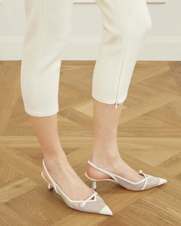 <a href="https://www.net-a-porter.com/en-us/shop/product/jimmy-choo/shoes/mid-heel/amita-45-embellished-patent-leather-trimmed-metallic-mesh-slingback-pumps/46376663163081774">JIMMY CHOO Amita Mesh Slingbacks</a> from Net-A-Porter, $925